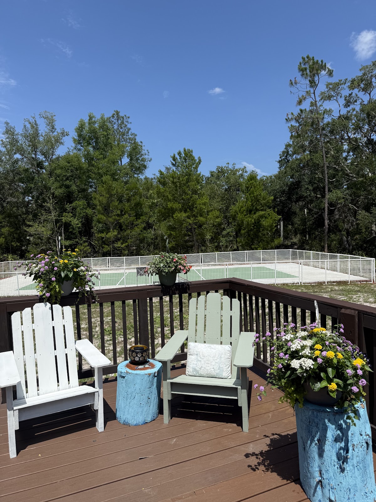 Deck seating with flowers overlooking the SoulNest pickleball court.